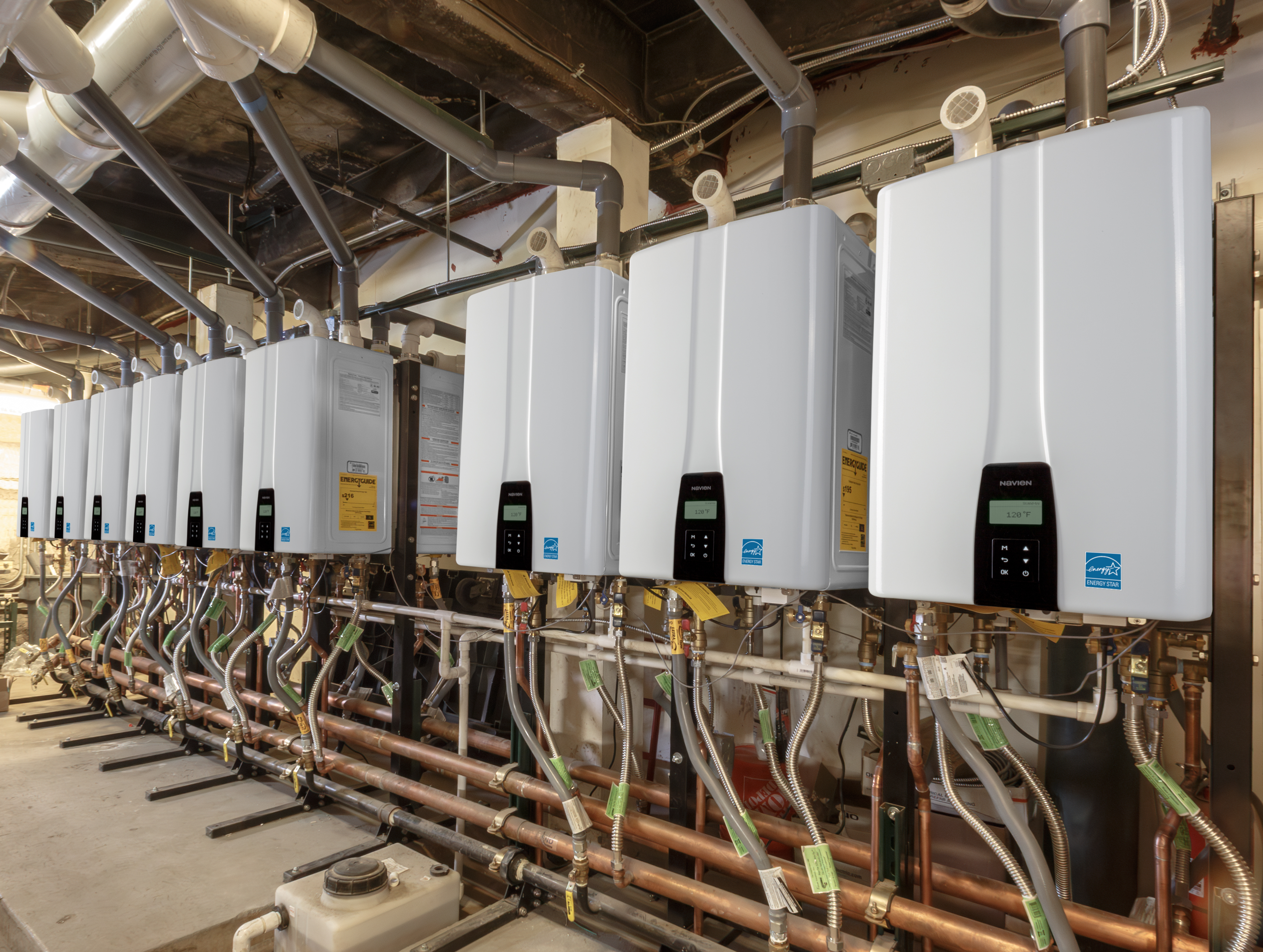installation of wall-mounted Navien NPE-2 tankless water heaters and NFB-C commercial boilers in the Denver Union Station basement mechanical room